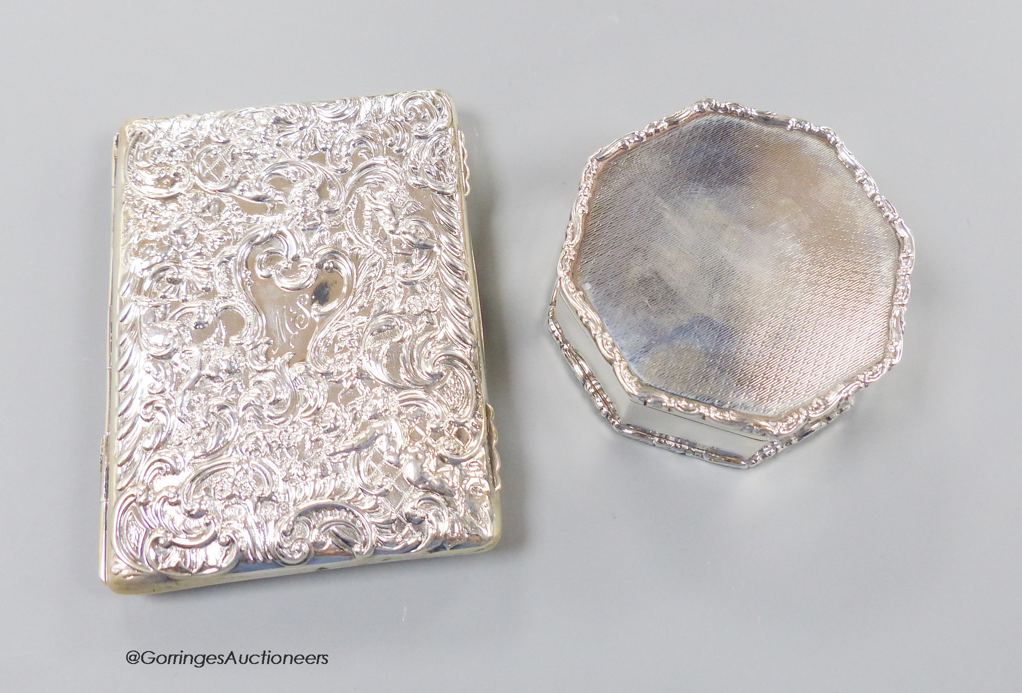 A late Victorian repousse silver mounted card purse, William Comyns, London, 1900, 10cm and a later silver octagonal trinket box.